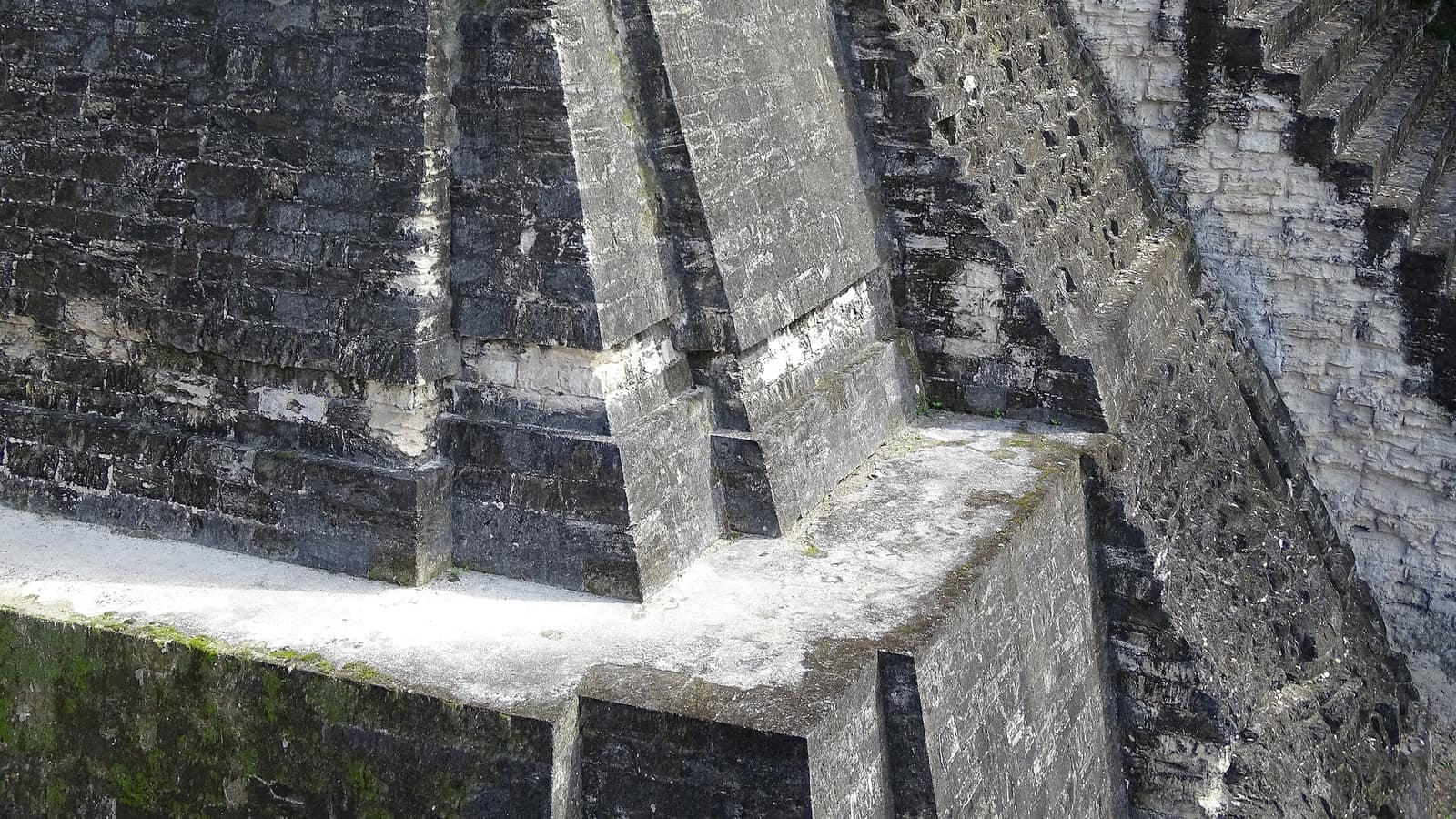 Close detail of the stepped grey limestone masonry of the North Acropolis at Tikal